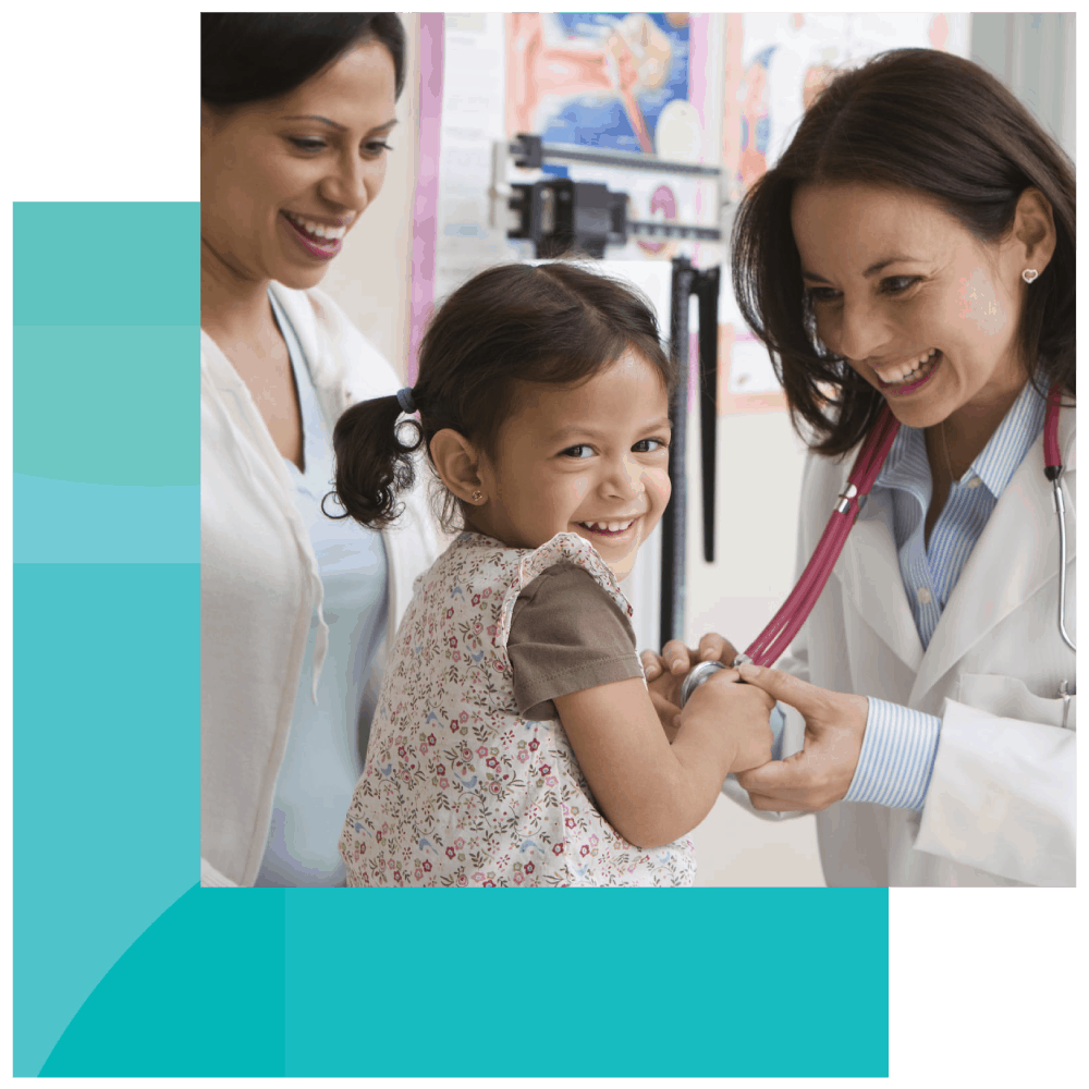  Everyone smiles as a pediatrician lets a young girl play with her stethoscope